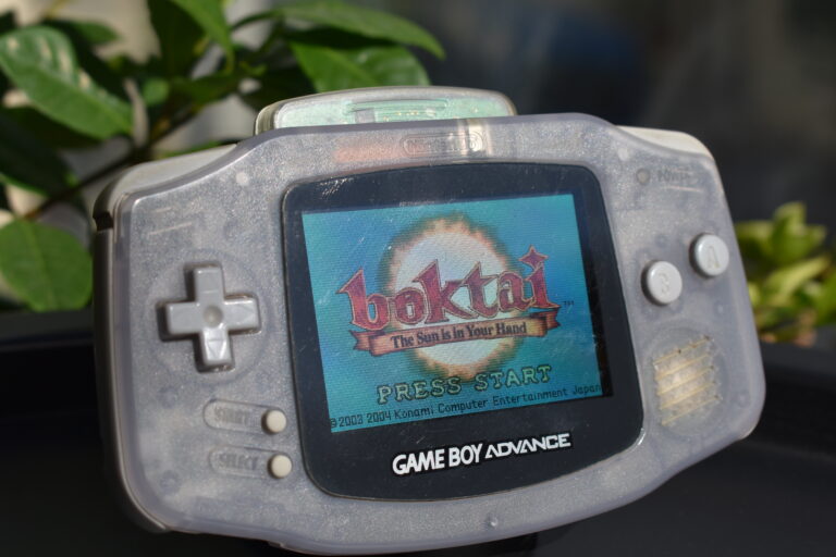 Game Boy Advance with Boktai in the cartridge slot, being hit by sunlight